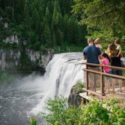 A family admiring Upper Mesa Falls from the viewing deck.