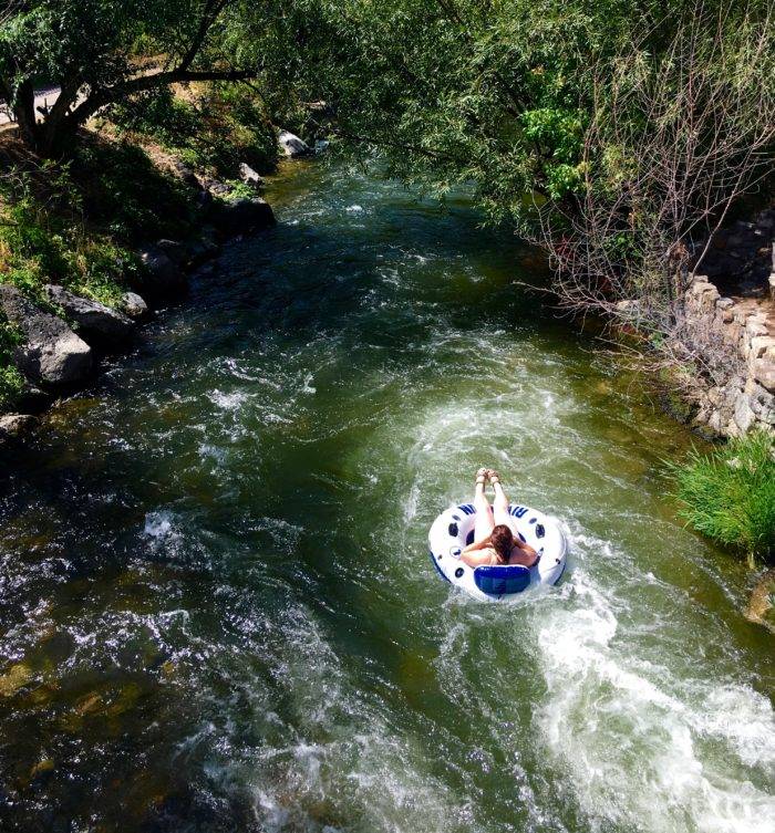 person floating a river in an inner tube