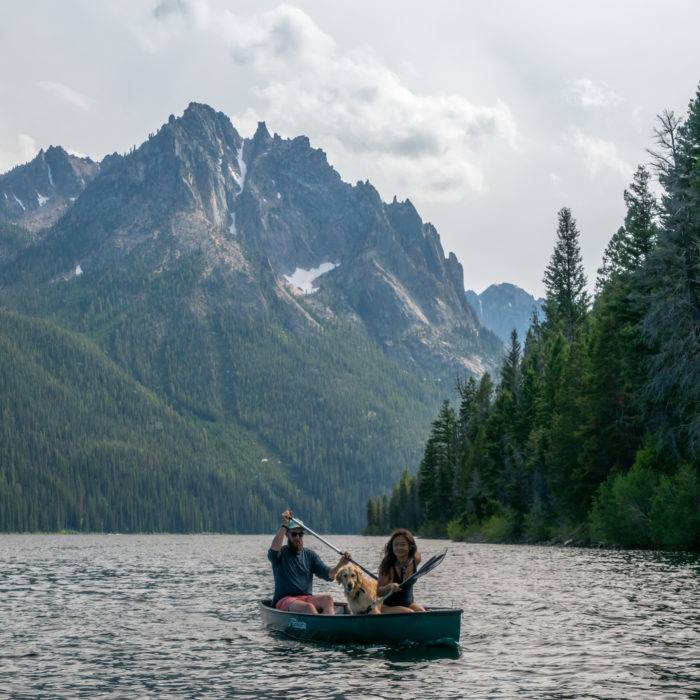 people canoeing on a mountain lake