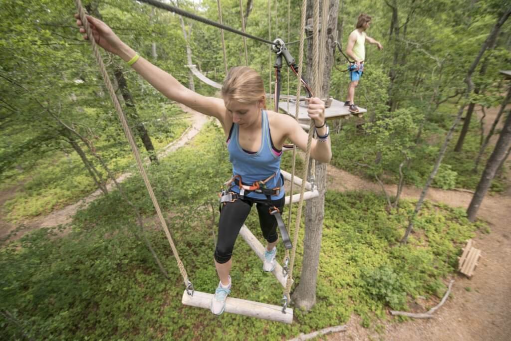 People on a ropes course at Tree to Tree Adventure Park.