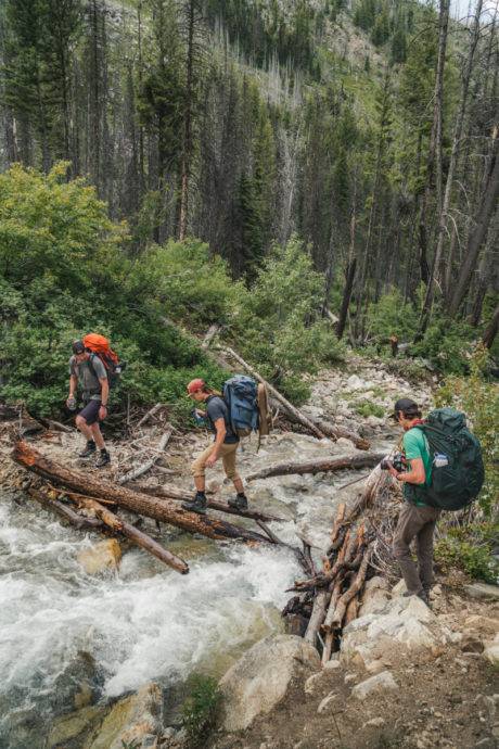 hikers crossing river