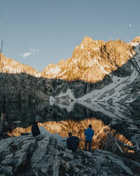 campers sitting by lake