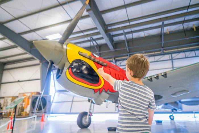 boy pointing at airplane