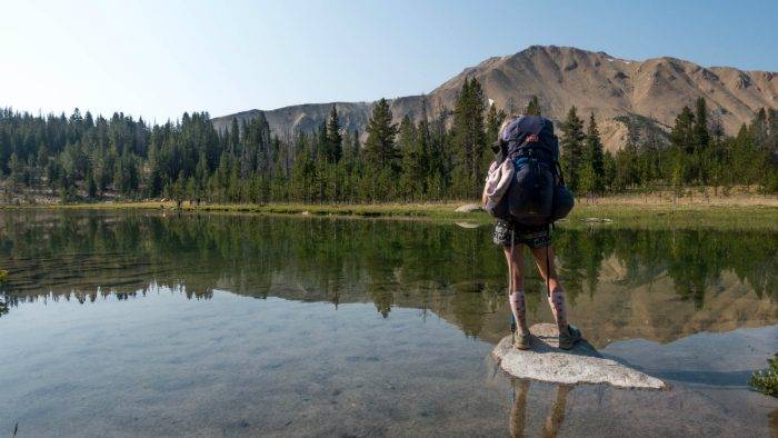 person standing at edge of lake