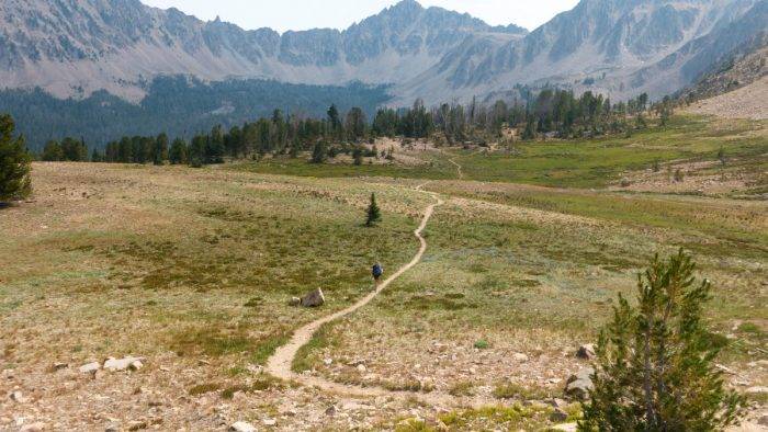 people hiking in mountain valley