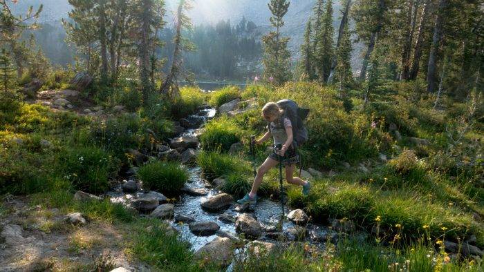 hiker crossing a stream