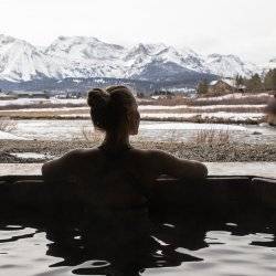 woman sitting in hot pool