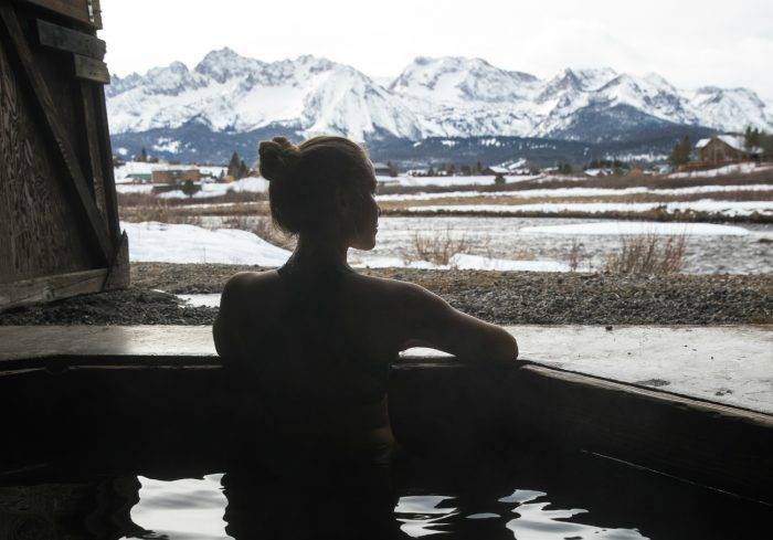 person sitting in a hot pool