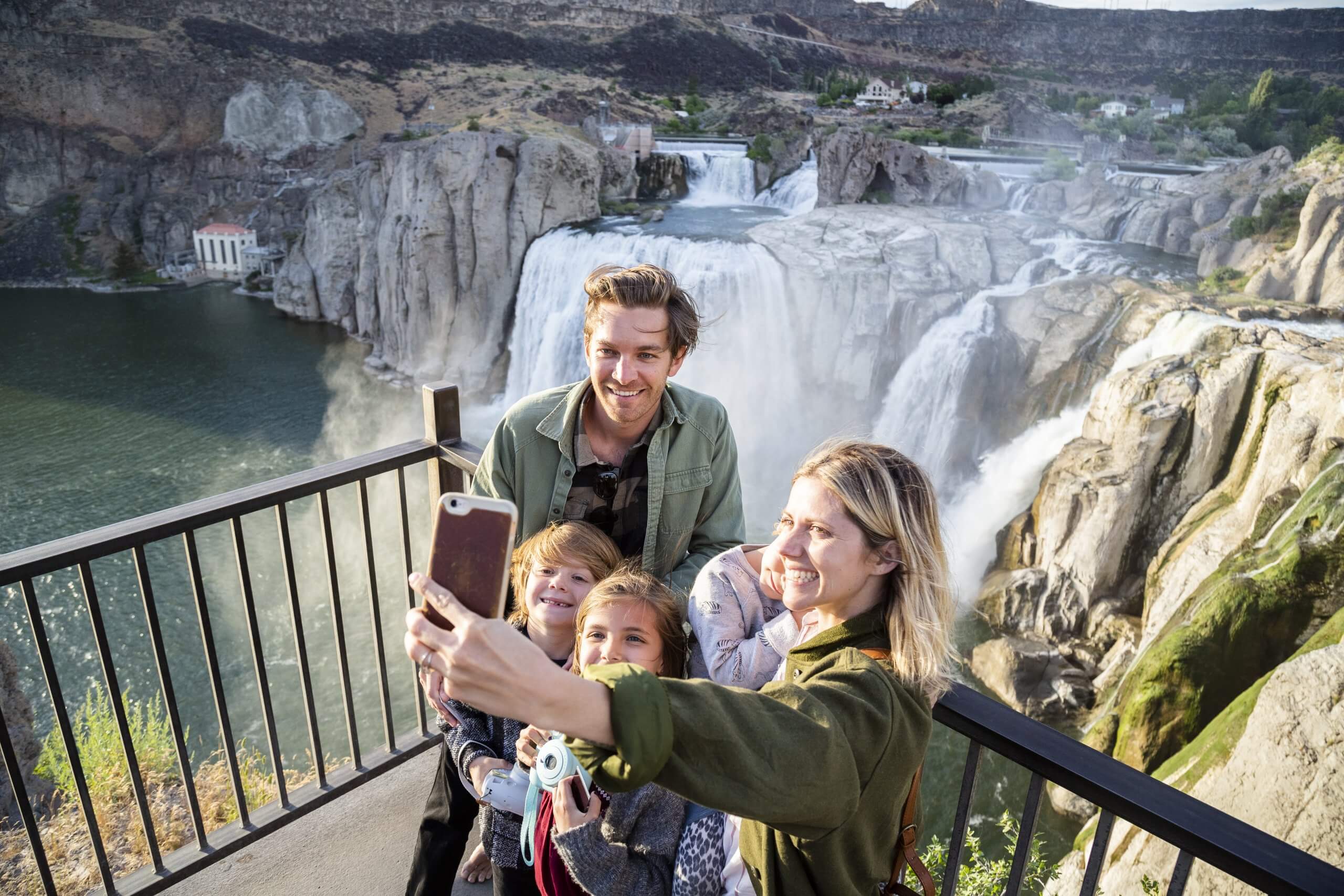 A family taking a selfie in front of Shoshone Falls.