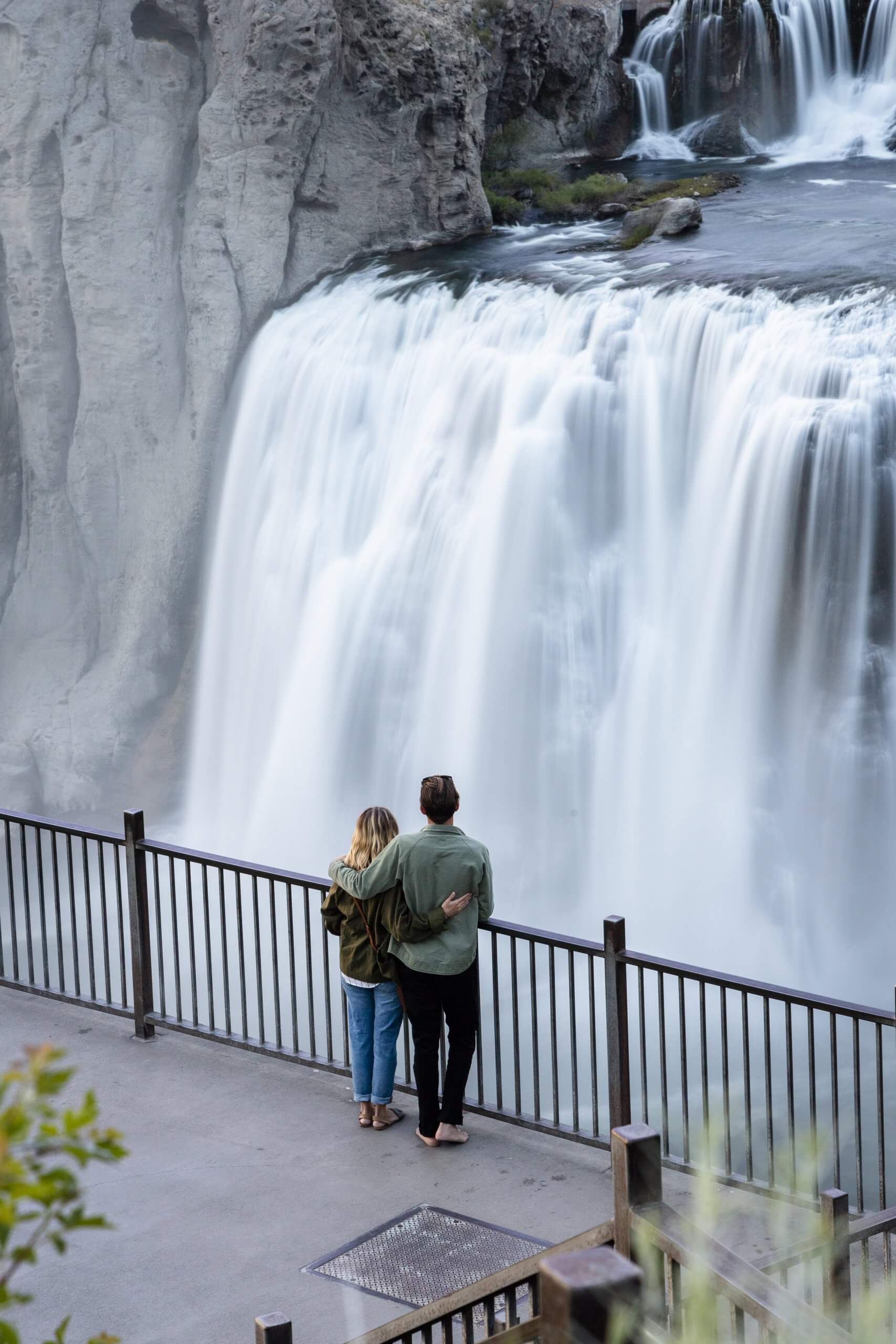 A mother and father admiring Shoshone Falls from the viewing deck.