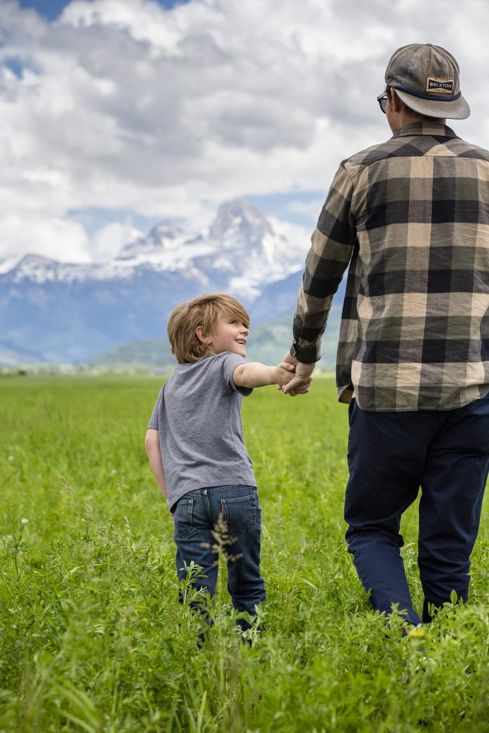 A child running through a valley with his father.