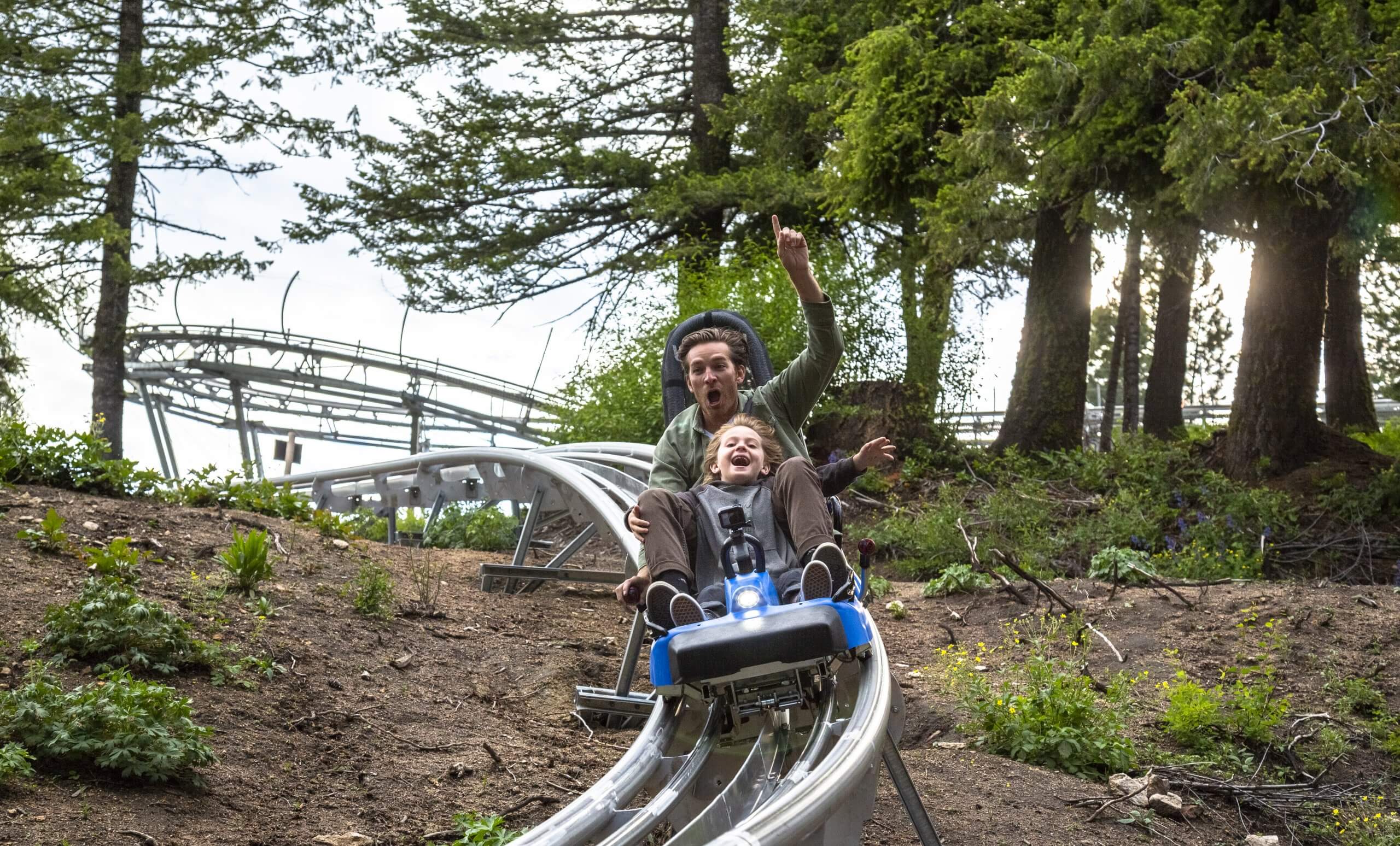 A family riding a mountain coaster.