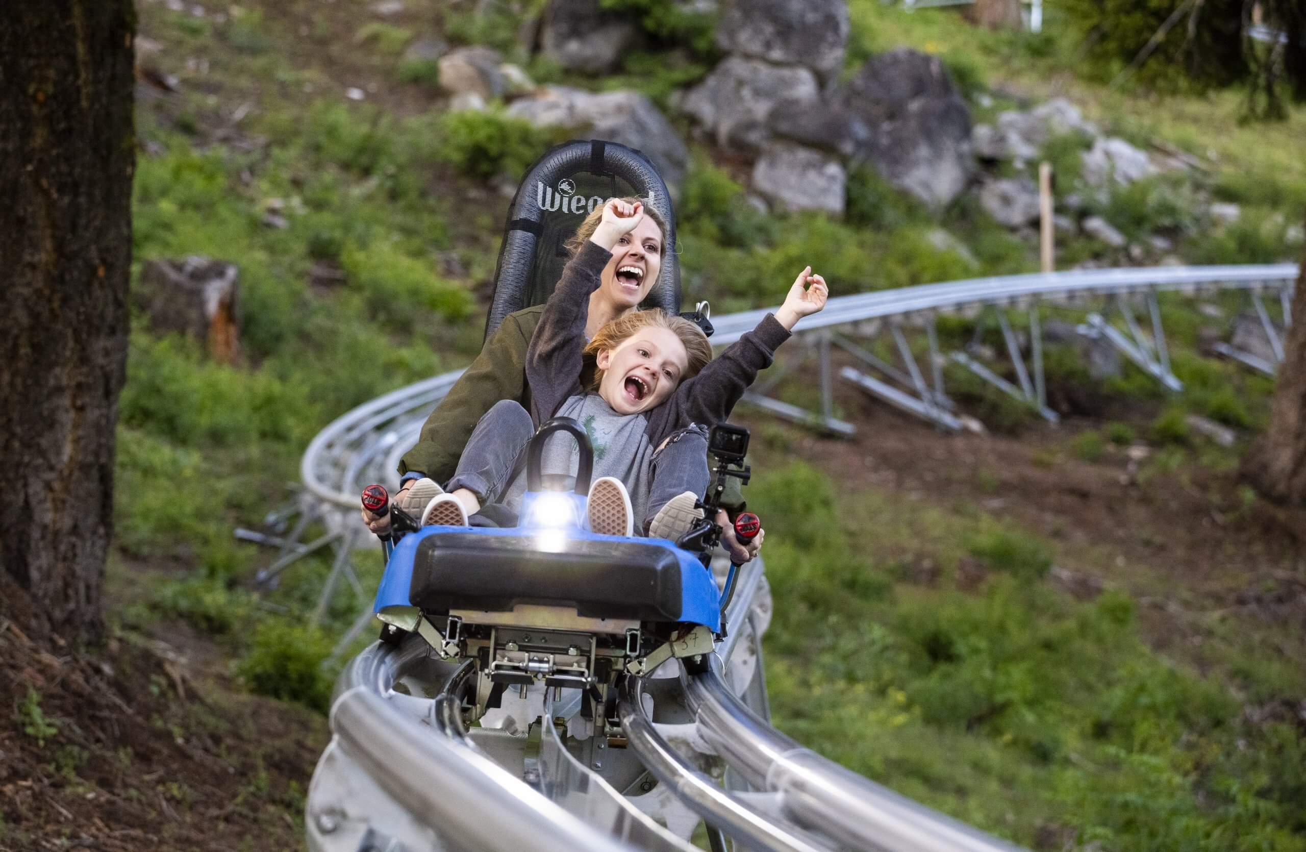 A family riding a mountain coaster at Bogus Basin Mountain Recreation area. 