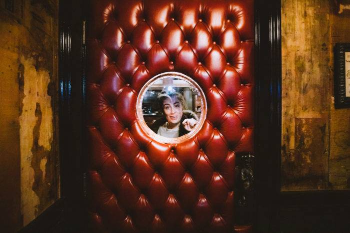 woman looking through door