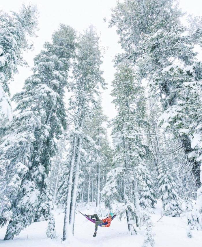 A man in a hammock in the snow.