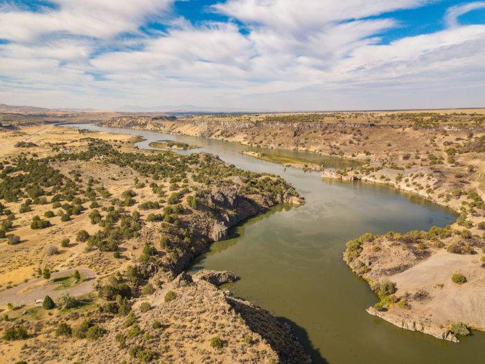 The Snake River winding through a sprawling desert landscape at Massacre Rocks State Park.