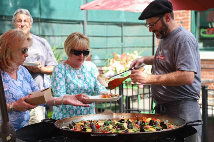 man serving paella