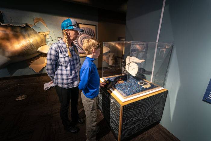 people standing at museum exhibit