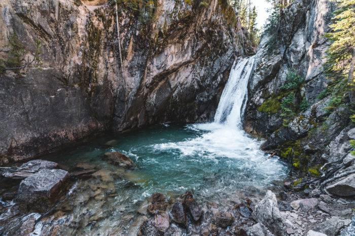 View of the alpine mountain waterfall, Lady Face Falls and the surrounding rocky surfaces.