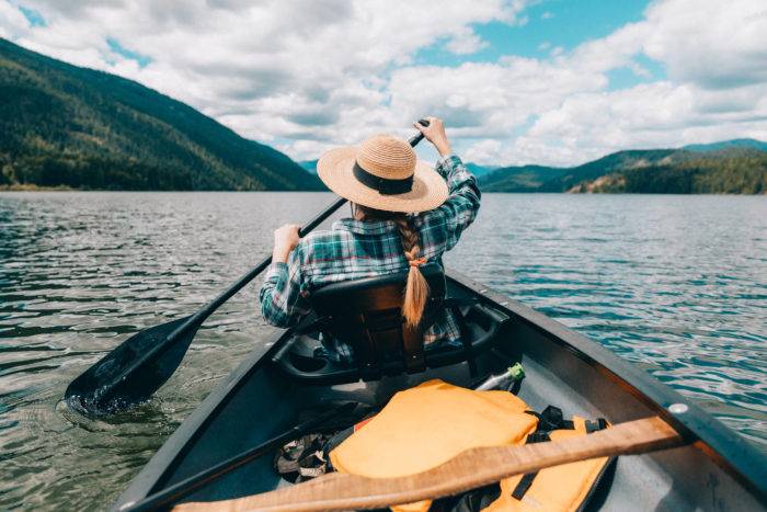 Woman canoeing on lake.