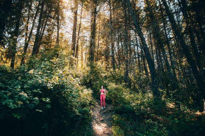 Woman hiking in forest.