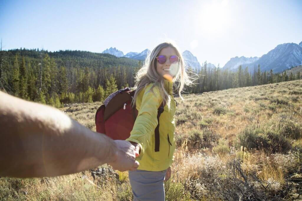 girl hiking with mountains in background.