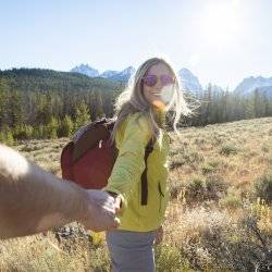 girl hiking with mountains in background.