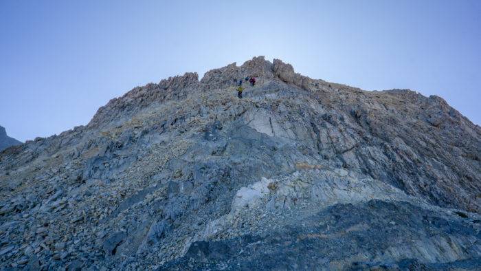 man climbing mount borah