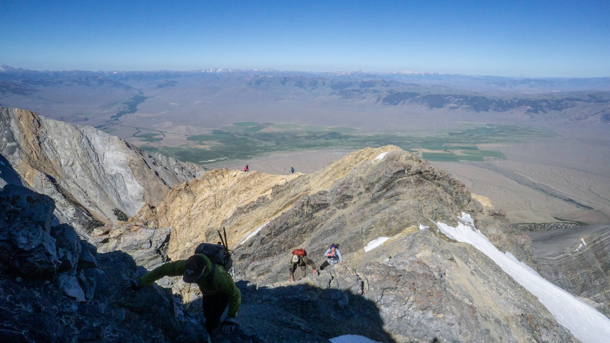 man climbing mount borah