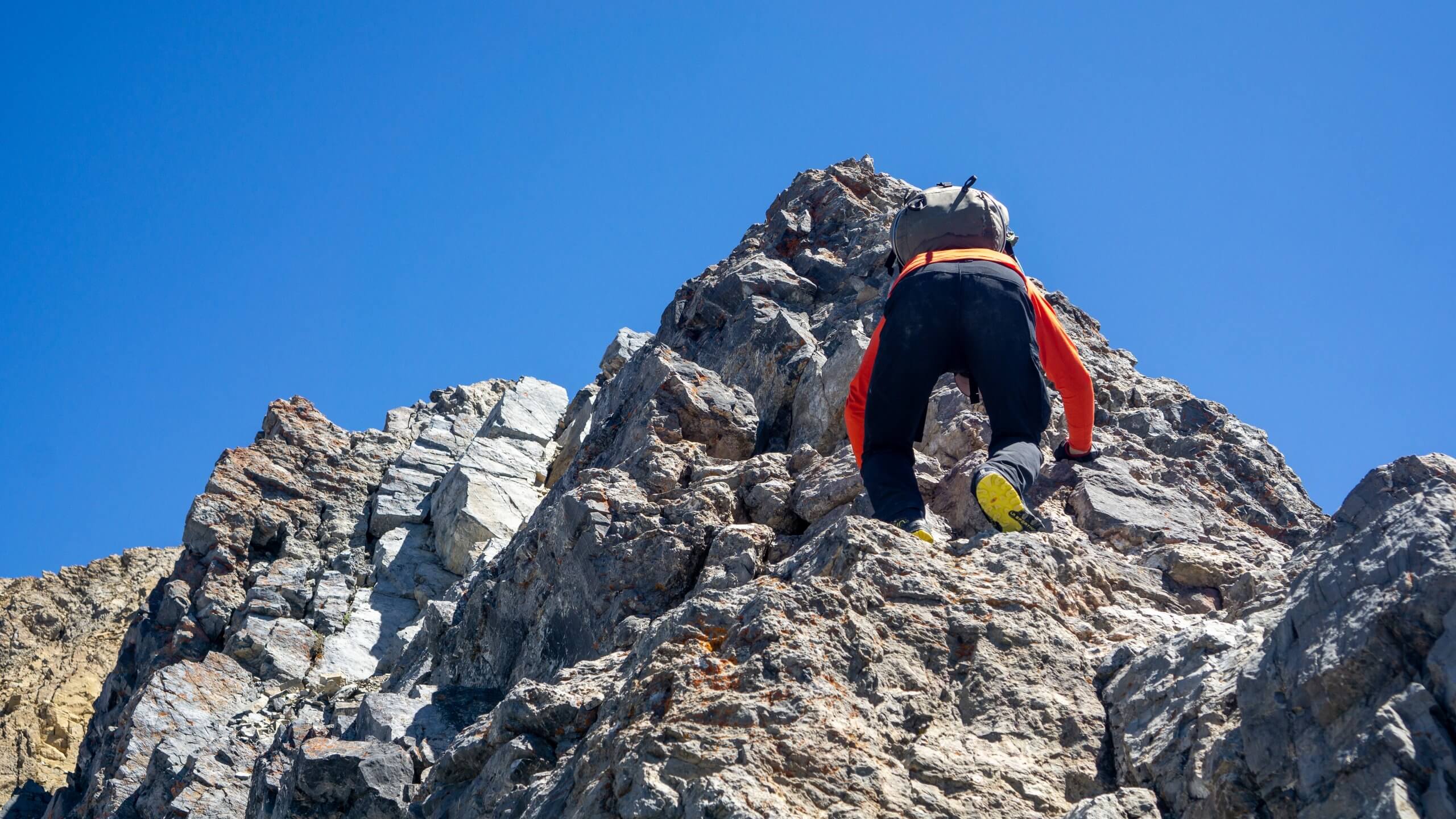 man climbing mount borah