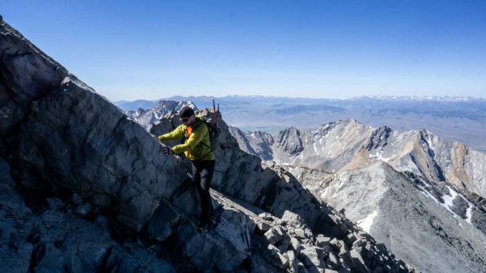 man climbing mount borah