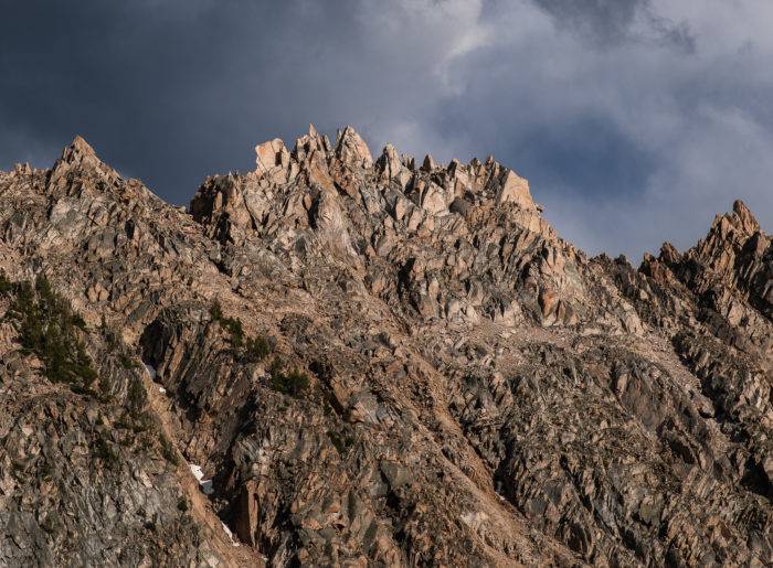 rugged mountain peak white clouds