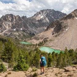 woman hiking high mountain lake