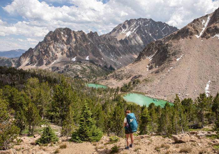 woman hiking high mountain lake