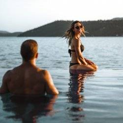 man and woman in infinity pool