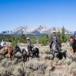 family on horseback ride in sawtooth mountains