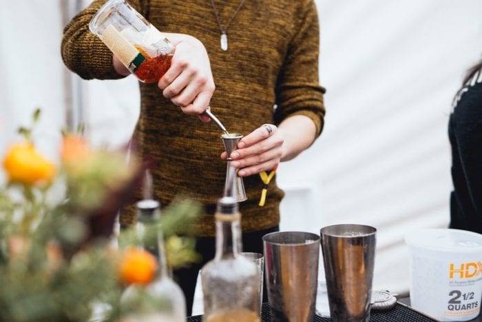 person pouring a drink