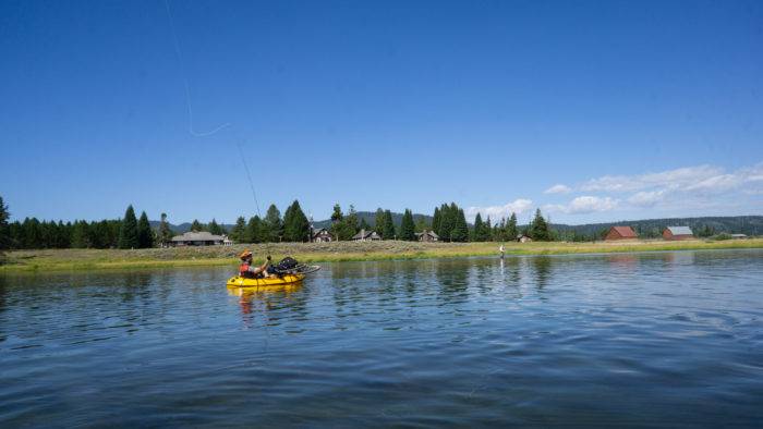 man in raft, fishing on river