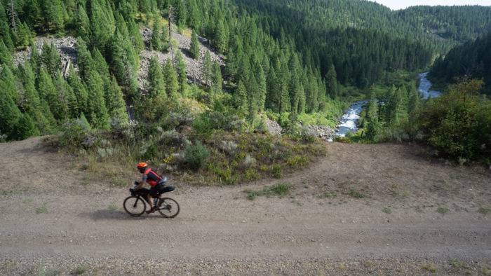 cyclist on a path, with river below