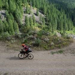 cyclist on a path, with river below