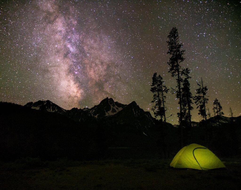 A green tent under night sky in Stanley, Idaho.