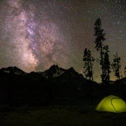 A green tent under night sky in Stanley, Idaho.