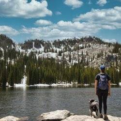 hiker looking at blue lake