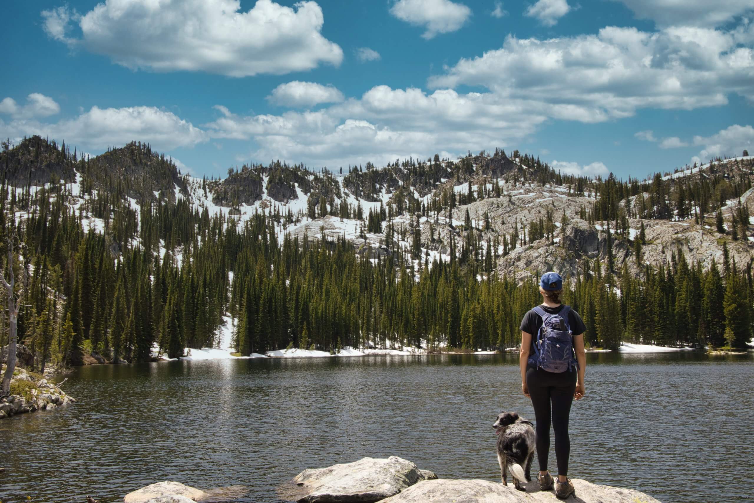 hiker looking at blue lake