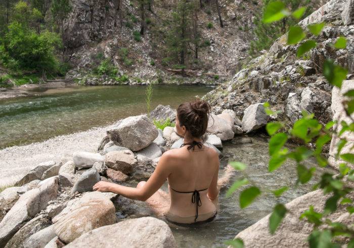 woman sitting in natural hot spring