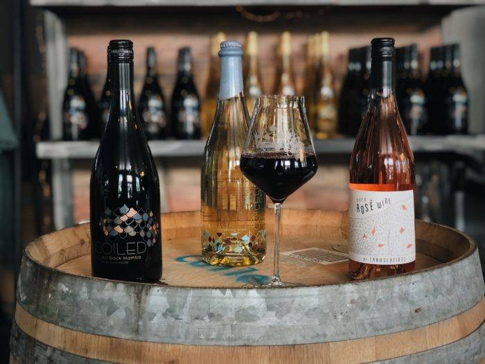 wine bottles and glasses on wine barrel