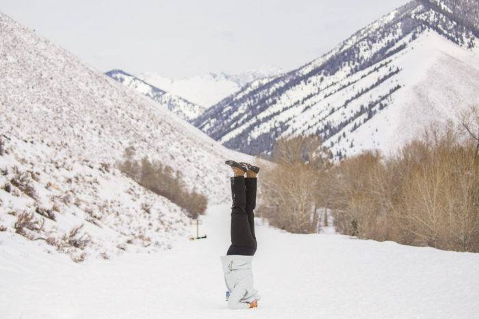 woman doing yoga in the snow