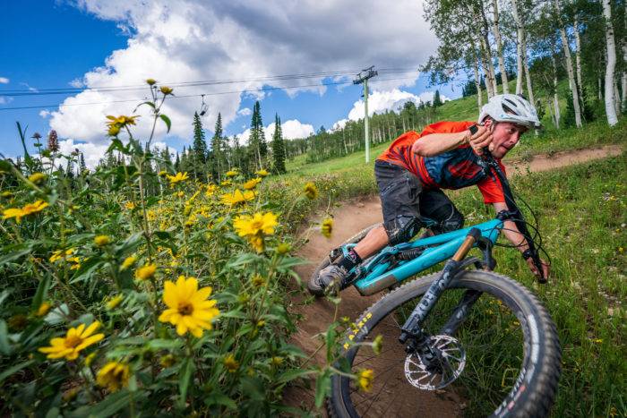 man cycling on mountain trail