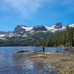 woman hiking near snowy mountain