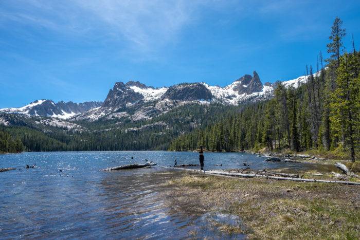 woman hiking near snowy mountain